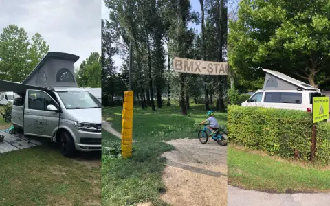 Kamper i rowerowy tor BMX na kempingu w Wiedniu. Dziecko na rowerze, baner "BMX-STAR".