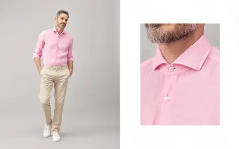 Uomo con camicia rosa e pantaloni beige, un look casual chic. Perfetto per abbinare camicia rosa uomo con stile.