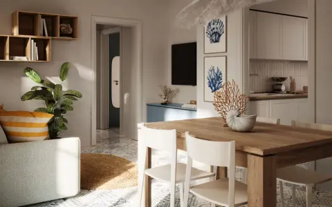 Tavolo in legno con sedie bianche, decorazioni marine e quadri a tema conchiglie: idee originali per arredare casa al mare.