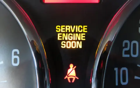Dashboard lights show "SERVICE ENGINE SOON" and a seatbelt warning. This is a common indicator that it's time to figure out how to reset check engine light.