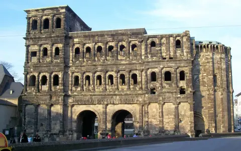 The Porta Nigra, a magnificent example of Trier Roman ruins, stands tall with its imposing stone structure and arched gateways.