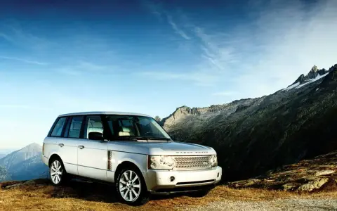 Srebrny Range Rover Vogue na tle górskich szczytów. Gotowy na każdą przygodę.