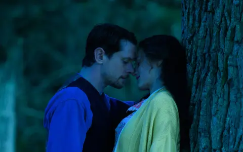 Intymny moment między parą w lesie, przypominający scenę z filmu "Kochanek Lady Chatterley" 2015.