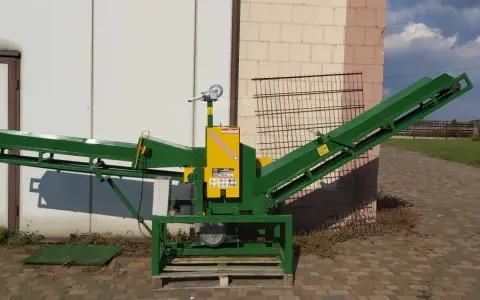 Zielony, dwutaśmociągowy rębaki do gałęzi, gotowy do pracy.
