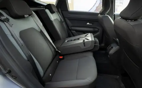 Interni Dacia Bigster: sedili posteriori in tessuto grigio e nero, bracciolo centrale ribaltabile con portabicchieri.