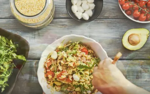 Przygotowanie pysznej sałatki z makaronem orzo z pomidorkami, mozzarellą i rukolą.