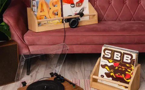 Gramofon i płyty winylowe na kanapie. Zastanawiasz się, czym czyścić płyty winylowe?