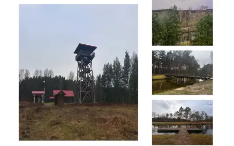 Wieża widokowa i małe budynki z czerwonymi dachami na tle lasu. W oddali widać fragmenty krajobrazu, mostek nad wodą i pomost. To miejsce przypomina akwedukt w Fojutowie.