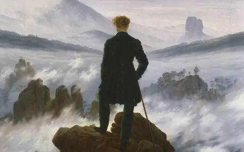 Hombre de espaldas, contemplando un paisaje brumoso y montañoso, al estilo de Caspar David Friedrich.