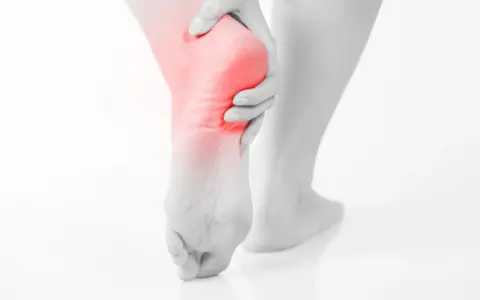 A person's foot with a red highlight on the heel, suggesting pain. This image evokes the relief of soaking an ankle in epsom salt.