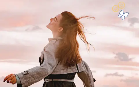 Embracing the sky, a woman with flowing red hair embodies joy, a feeling achievable through 7 daily habits. A butterfly and smiley faces float above.