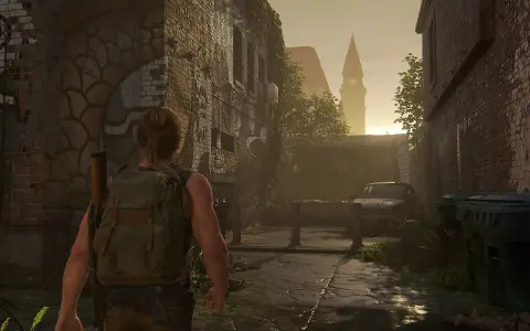 Abby camina por una calle desolada, reflexionando sobre cuanto dura The Last of Us 2. El sol se pone tras una torre.