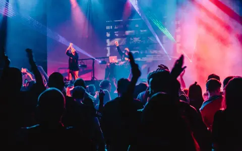 Eine Menge feiert zu A&R Music bei einem Konzert mit Lasershow.