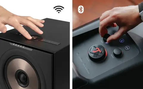 Hände bedienen Lautsprecher. Ein Lautsprecher zeigt ein WLAN-Symbol, der andere ein Bluetooth-Symbol. So funktioniert Bluetooth: kabellose Verbindung für Musik.