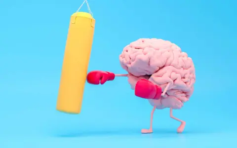 Cervello con guantoni da boxe rosa colpisce un sacco giallo, un modo per risollevare l'umore.