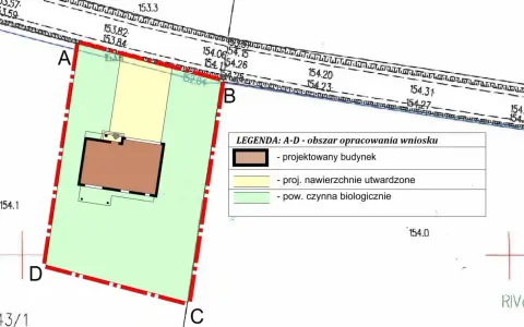 Fragment planu zagospodarowania przestrzennego: projektowany budynek, nawierzchnie utwardzone i powierzchnia biologicznie czynna.