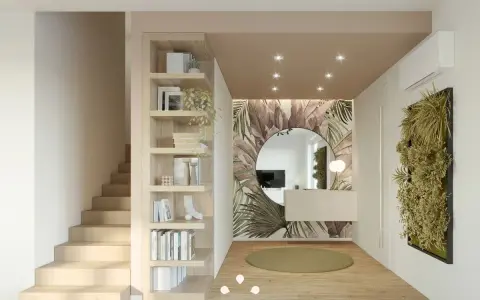 Ingresso ampio con libreria a giorno, scala in legno, specchio rotondo e carta da parati tropicale. Idee per come arredare un ingresso grande con stile.