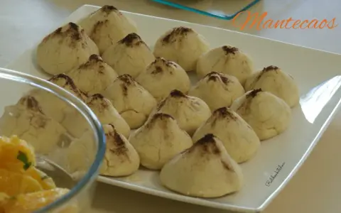 Douceurs de la recette montecao, des biscuits sablés saupoudrés de cacao, prêts à être dégustés.