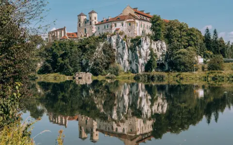 Opactwo Benedyktynów w Tyńcu, malowniczo położone na skale nad Wisłą, odbija się w spokojnej tafli rzeki. Tyniec Kraków.