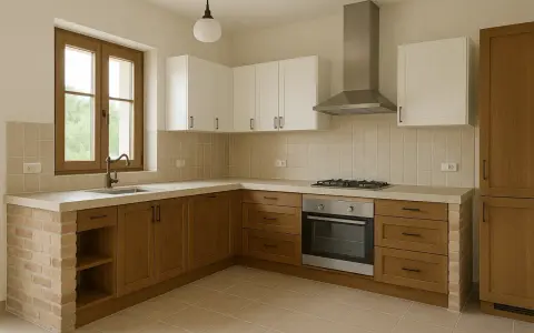 Cocina de obra con encimera de hormigón, muebles de madera y ladrillo visto. Ventana con grifo y campana extractora sobre la vitrocerámica.
