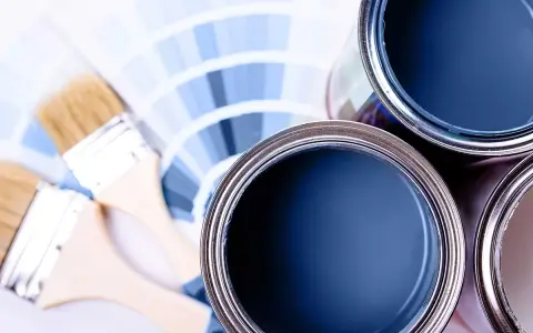 Lattine di vernice blu e pennelli su campioni di colore. Ideale per la vernice per mdf.