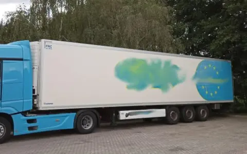 Niebieska ciężarówka z naczepą, na której widnieje symbol UE. Obok stoi biały bus inspekcji transportu drogowego. Certyfikat ATP potwierdza gotowość do przewozu.