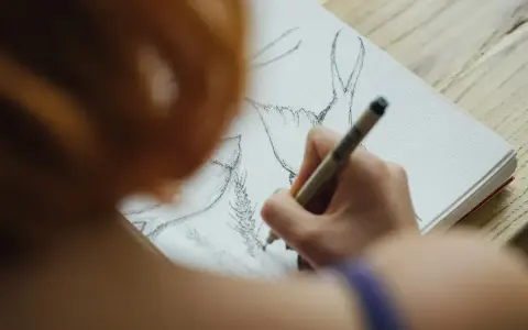 Artystka szkicuje jelenia na papierze akwarelowym. Różne rodzaje papieru oferują unikalne tekstury do rysowania.