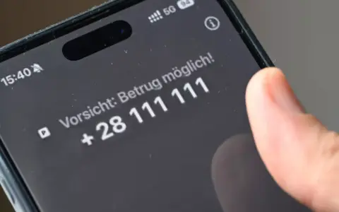 Vorsicht: Betrug möglich! Ein Finger tippt auf dem Smartphone, um Spam-Anrufe zu blockieren.