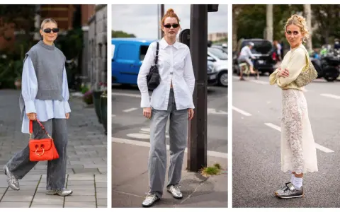 Tre donne sfoggiano un outfit elegante con sneakers donna: look casual chic con gilet grigio, camicia bianca e gonna in pizzo.