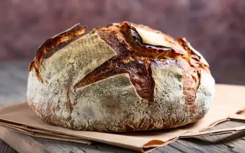 Pane fatto in casa con lievito di birra, croccante fuori e morbido dentro, pronto per essere gustato.
