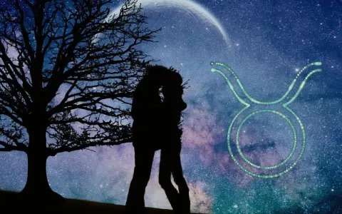 Sylwetka pary całującej się pod drzewem na tle nocnego nieba z księżycem i symbolem Byka. Byk znak zodiaku charakterystyka.
