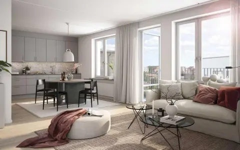 A bright, modern living room and kitchen with a dining table, sofa, and large windows.