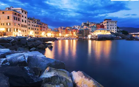 Case colorate illuminate sul mare calmo, la **riviera ligure di levante** incanta al crepuscolo.