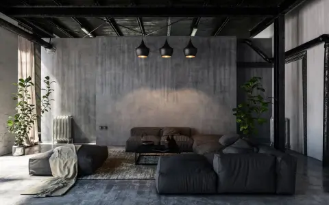 Nowoczesny salon w stylu industrialnym i loftowym. Betonowe ściany, czarne lampy, wygodna, szara sofa i rośliny tworzą surowy, ale przytulny klimat.