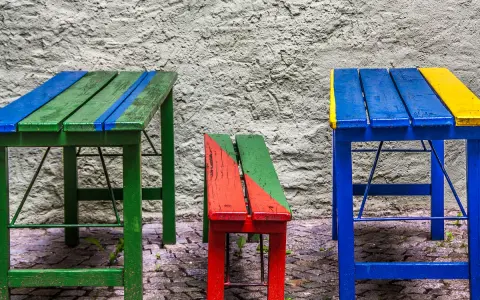 Muebles coloridos, como mesas y bancos, hechos con **objetos reciclados fáciles de hacer**.