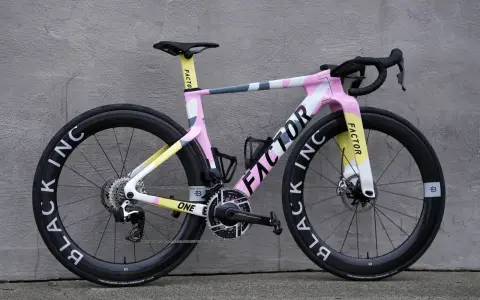 A stylish pink, yellow, and grey Factor road bike, perfect for women beginners looking for a fun and fast ride.