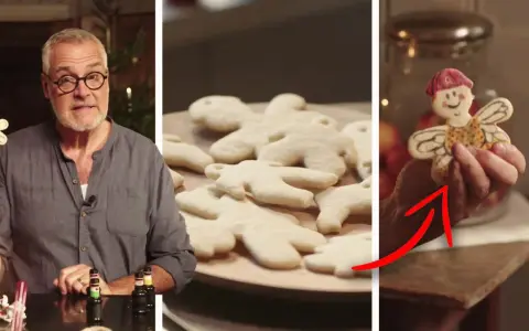 Man visar en vit pepparkaka formad som en figur. En annan vit pepparkaka med ansikte och vingar visas.