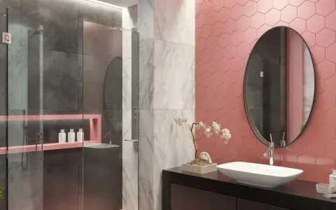 Bagno moderno con pareti rosa a nido d'ape, doccia in vetro e marmo. Un lavabo ovale su mobile nero e specchio rotondo completano le idee bagno rosa.
