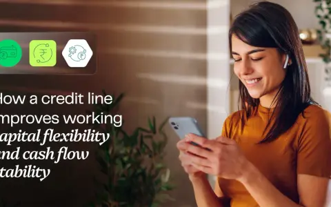 A woman smiles while looking at her phone, with icons representing financial flexibility and a working capital line of credit.