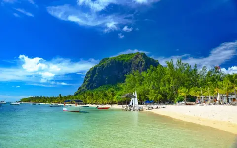 Rajskie plaże Mauritiusa: turkusowa woda, biały piasek, palmy i majestatyczna góra Le Morne Brabant.