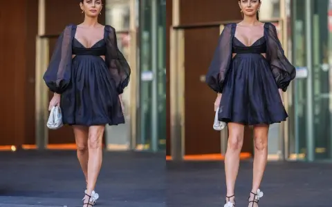 Elegancka czarna sukienka z bufiastymi rękawami i wycięciami. Idealna stylizacja, jak się ubrać na 40 urodziny w lokalu, by wyglądać zjawiskowo.