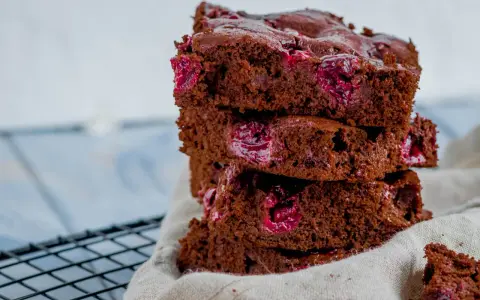 Ein Stapel saftiger Schoko Kirsch Kuchen Blech Stücke mit saftigen Kirschen.