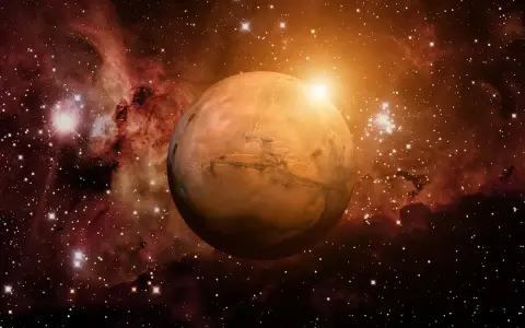 El planeta Marte brilla en el cosmos, rodeado de nebulosas y estrellas. Su superficie rojiza evoca la energía de una marte carta astral, guiando destinos.