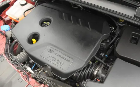 Silnik Ford Focus MK3 1.6 TDCI. Widoczna czarna osłona silnika z napisem "Ford Duratorq TDCI".