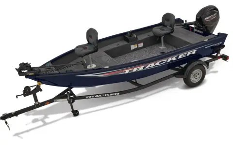 Un bateau Tracker bleu foncé sur sa remorque, prêt pour l'aventure.