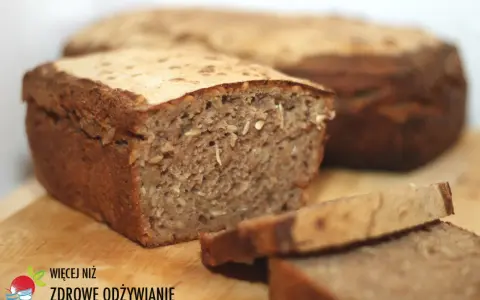 Chleb żytni z ziarnami, pokrojony na kromki, na drewnianej desce.
