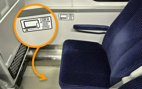 Na siedzeniu w TLK jest naklejka informująca, że pod siedzeniem znajdują się gniazdka 230V.