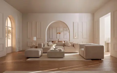 Salon lumineux aux murs beiges et moulures. Le mobilier, aussi beige, crée une ambiance douce. Quel couleur va avec le beige ? Le bois du parquet apporte une touche chaleureuse.