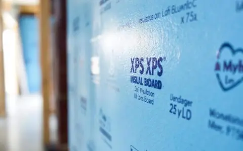 Panneau bleu clair d'isolant polystyrène extrudé XPS, prêt pour l'isolation d'une maison.