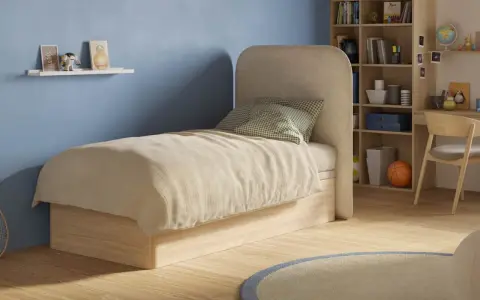 Chambre d'ado avec un matelas confortable, une étagère murale décorée et une bibliothèque remplie de livres et de jouets.